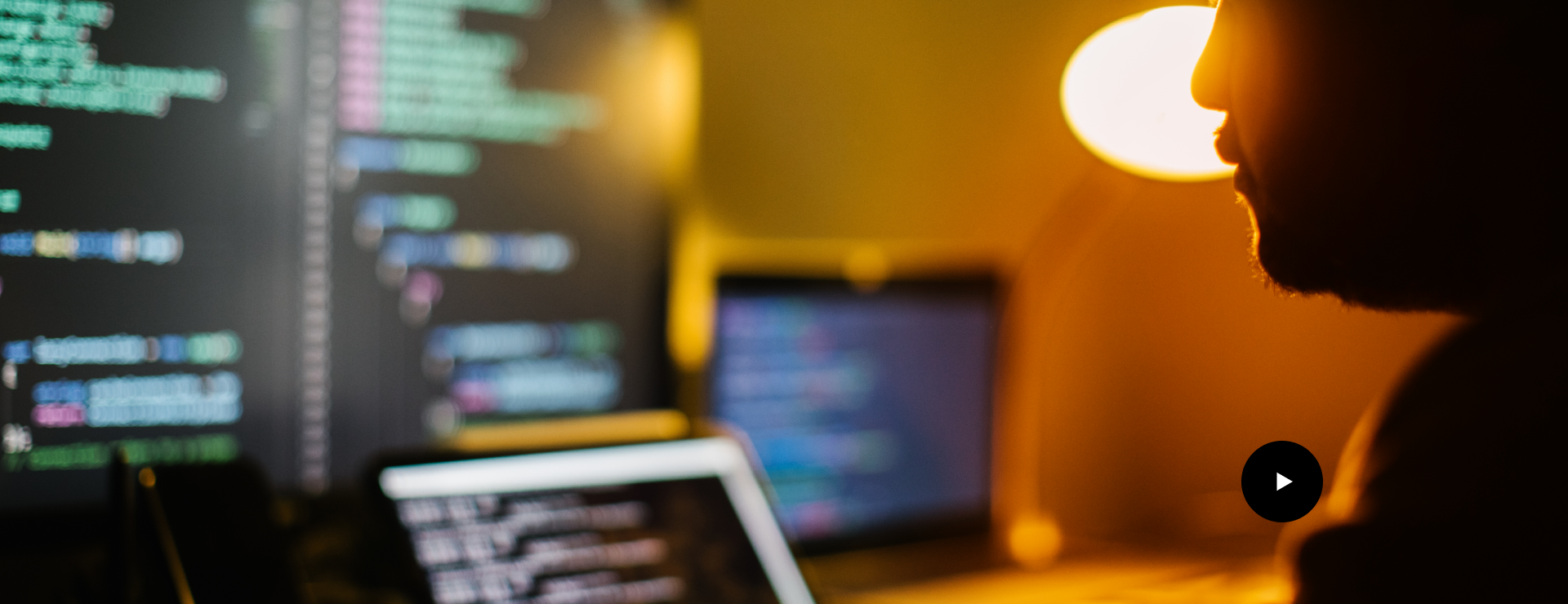 Developer working in front of code screens